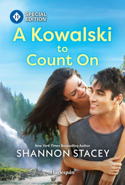 Cover for A Kowalski To Count On by Shannon Stacey. Image is a couple in front of a waterfall in the woods, both wearing summer T-shirts. They both have dark hair, and she’s got her arms wrapped around him from behind, as though getting a piggy-back ride.